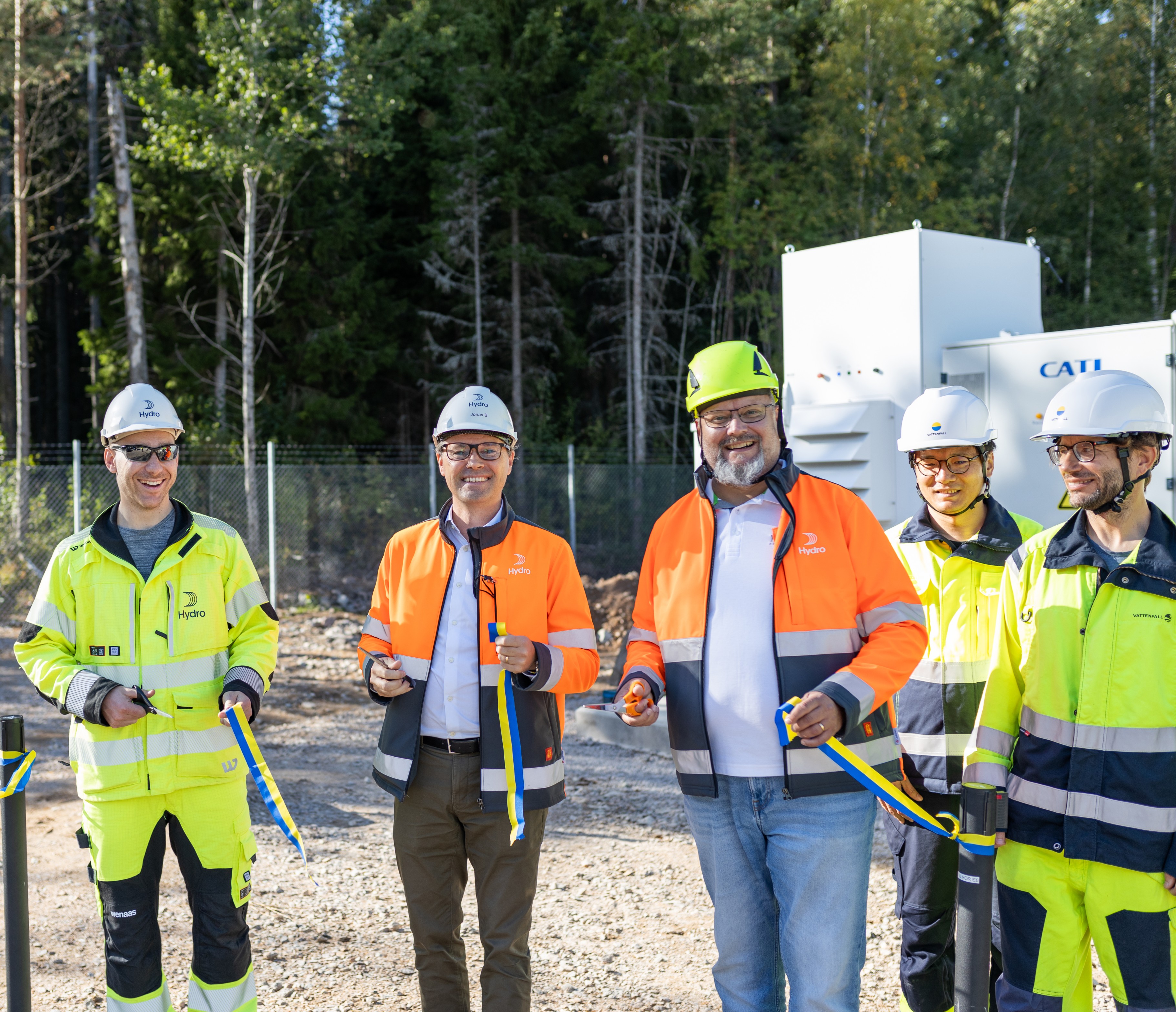 a group of men wearing safety vests and standing outside