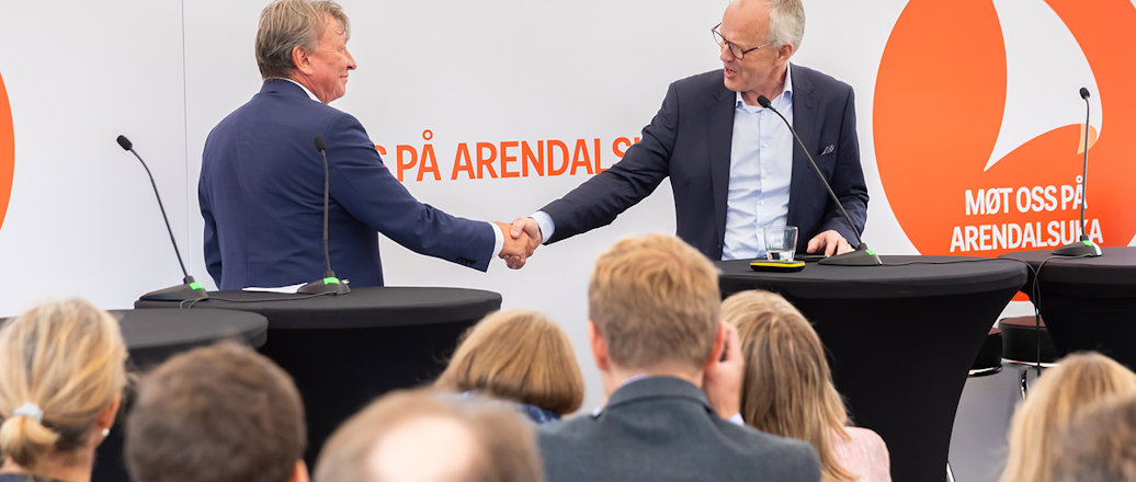 a man shaking hands with a man