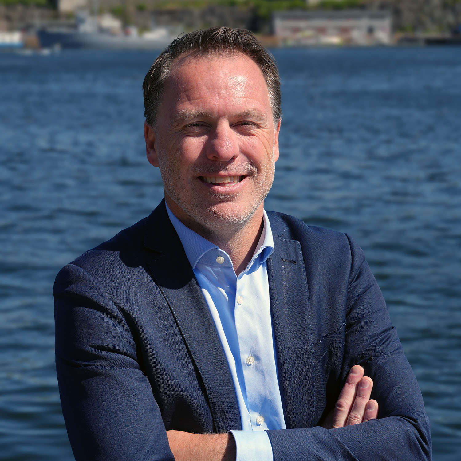 a man in a suit with his arms crossed