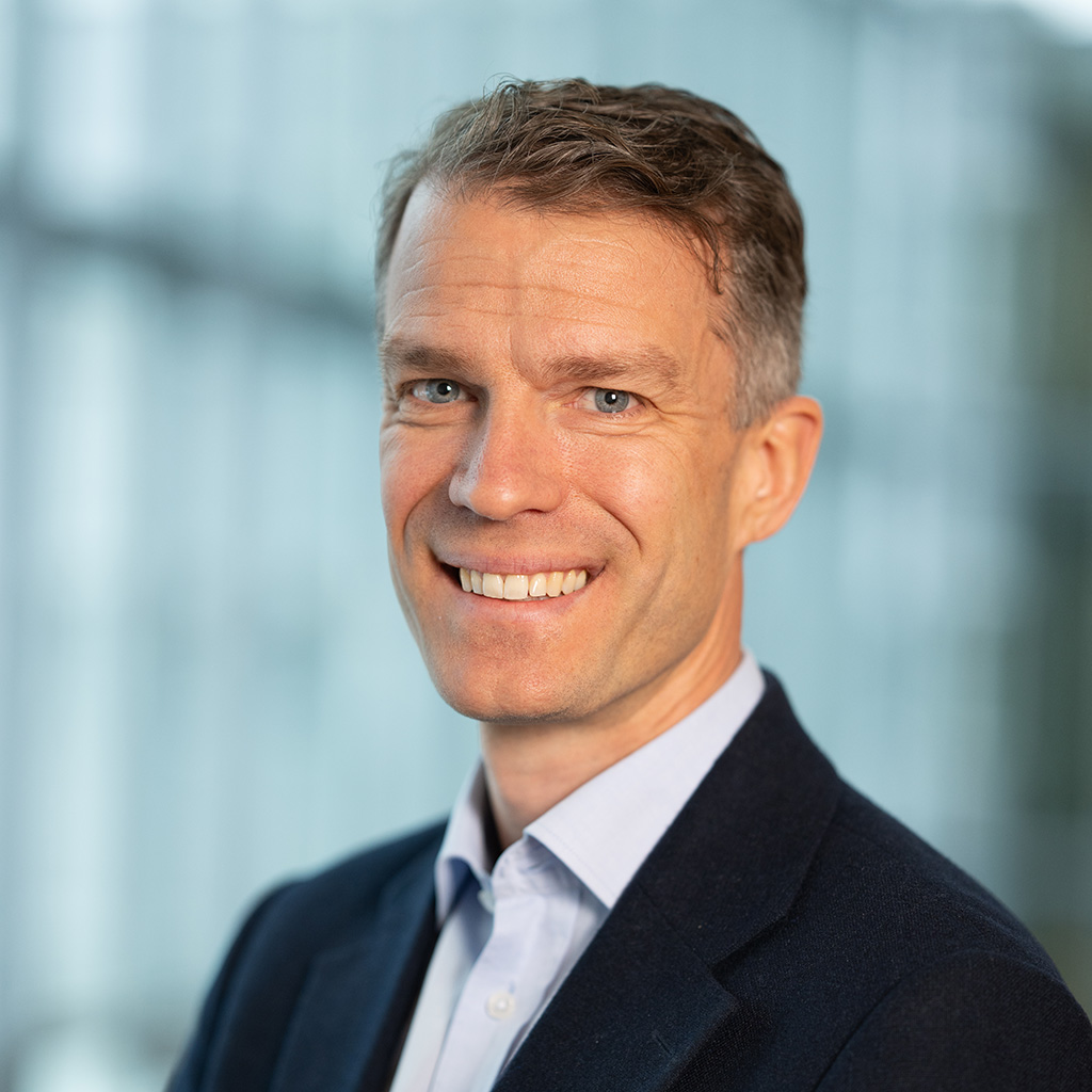 a man in a suit smiling